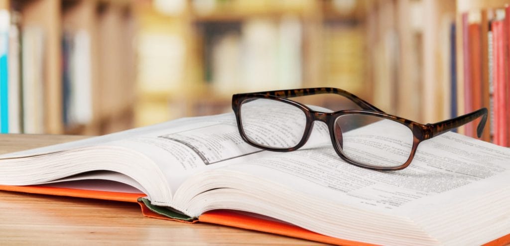 A book and a pair of glasses in a library