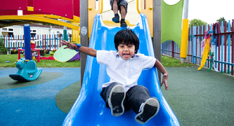 child going down slide