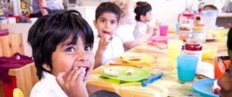 Children eating food at a table