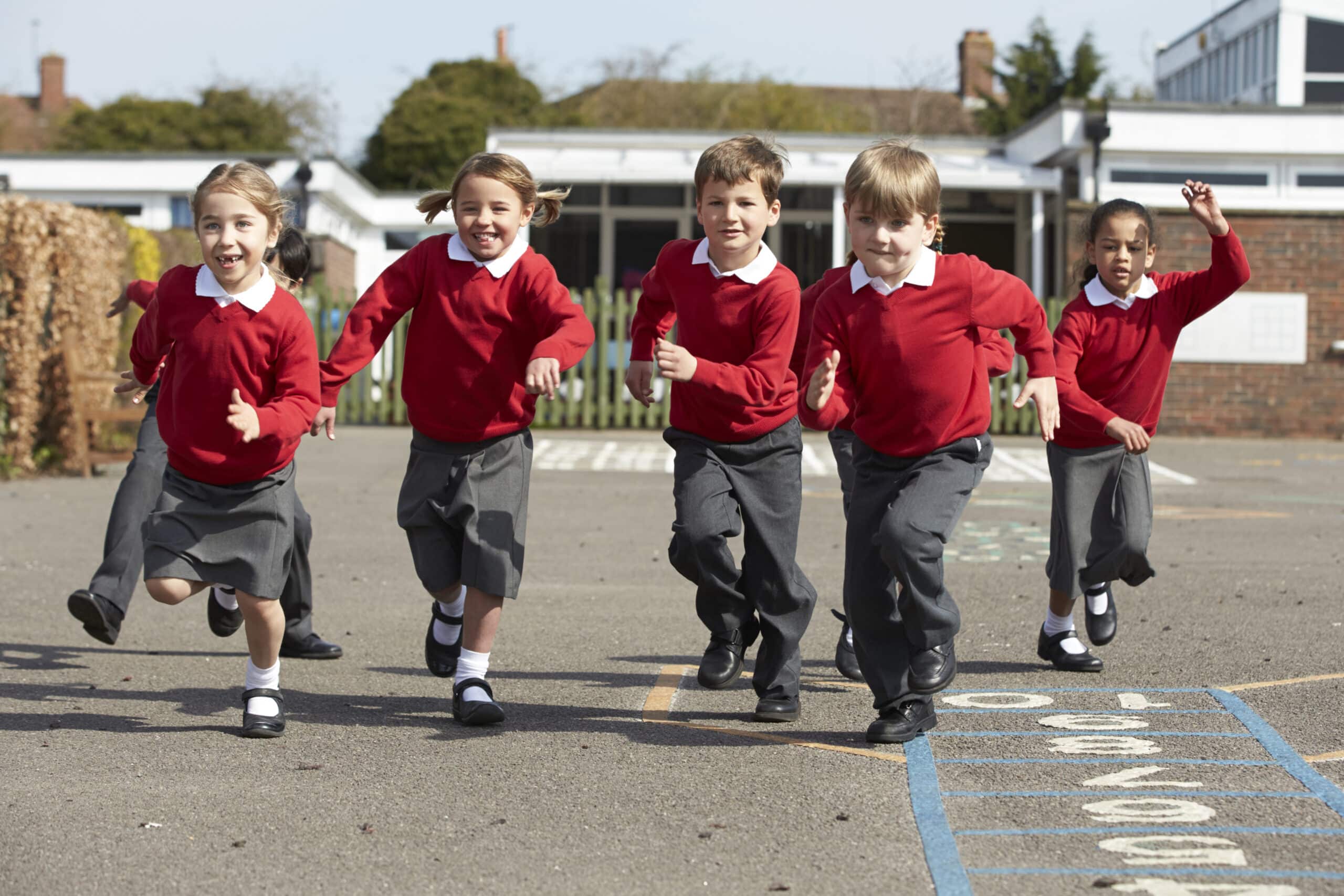 A group of children running in the playground at school