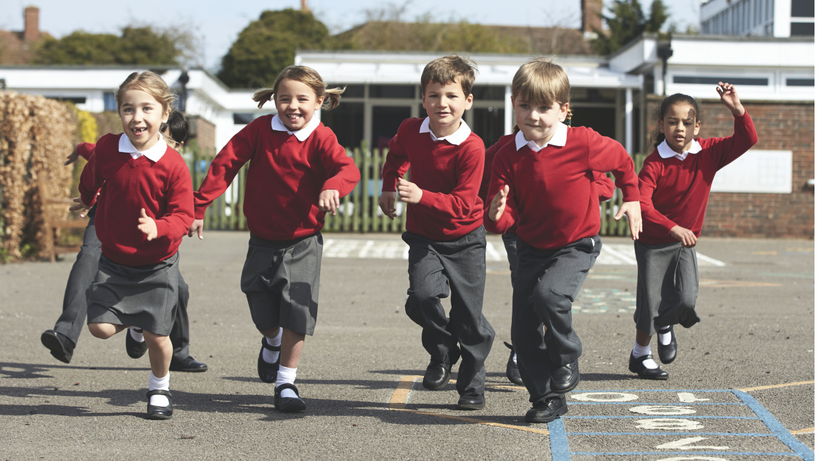 A group of school children running in the playground