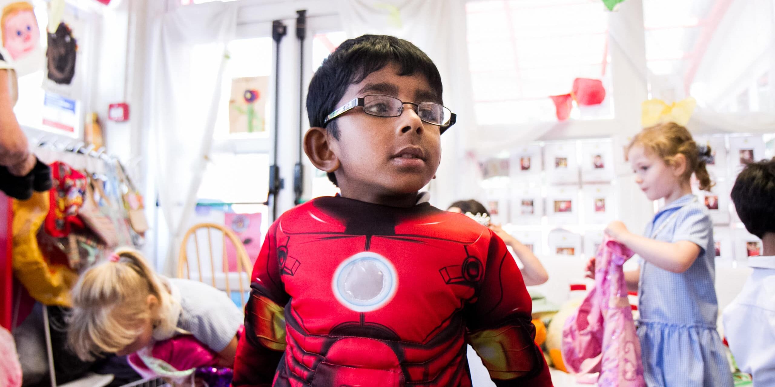 A boy dressed as a superhero in a nurture group at school